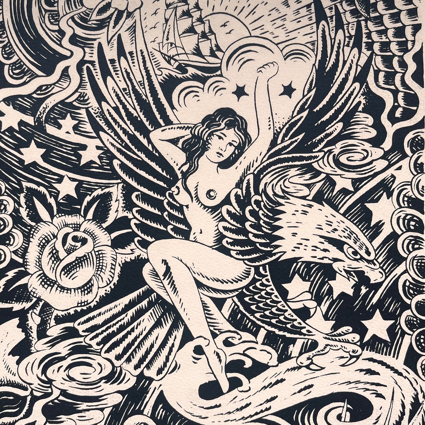 Black and white tattoo design brush pen illustration featuring Japanese background of waves, clouds, and lightening. An Ed hardy woman on an eagle, a skull, a rose, and a ship