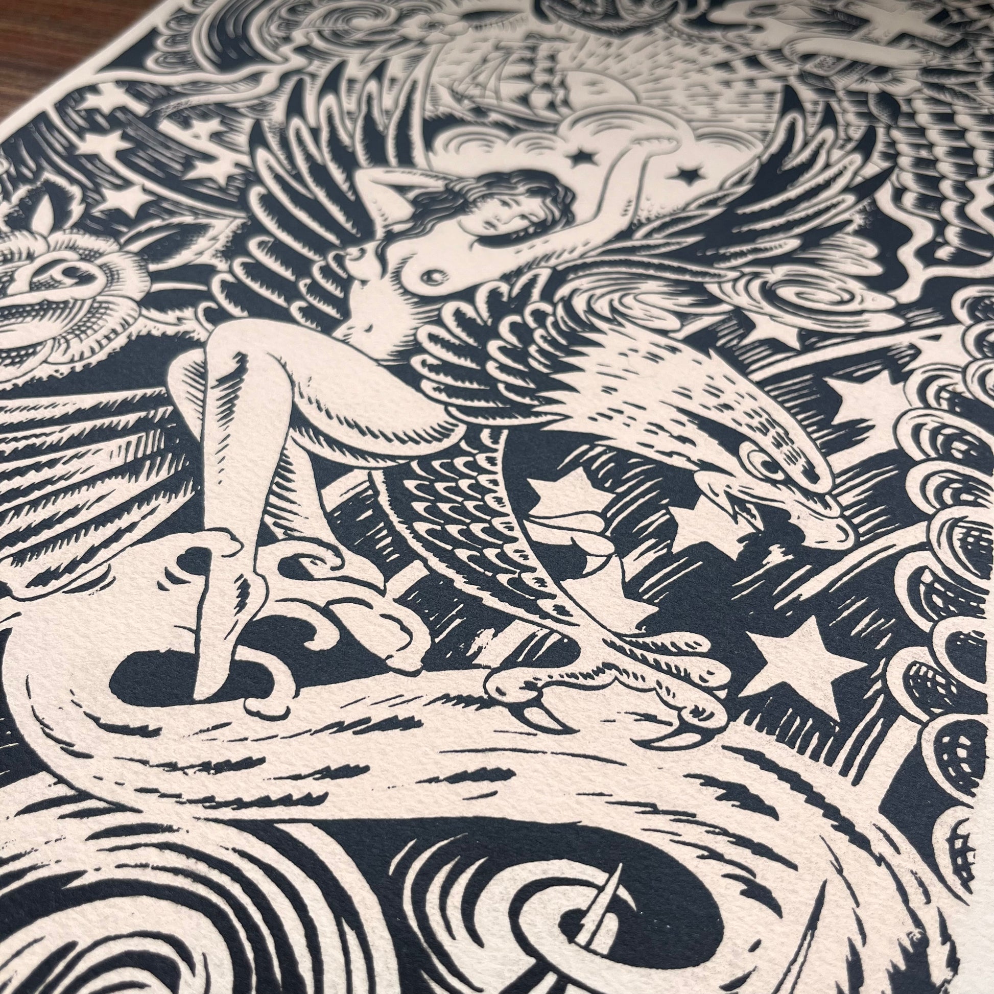 Black and white tattoo design brush pen illustration featuring Japanese background of waves, clouds, and lightening. An Ed hardy woman on an eagle, a skull, a rose, and a ship