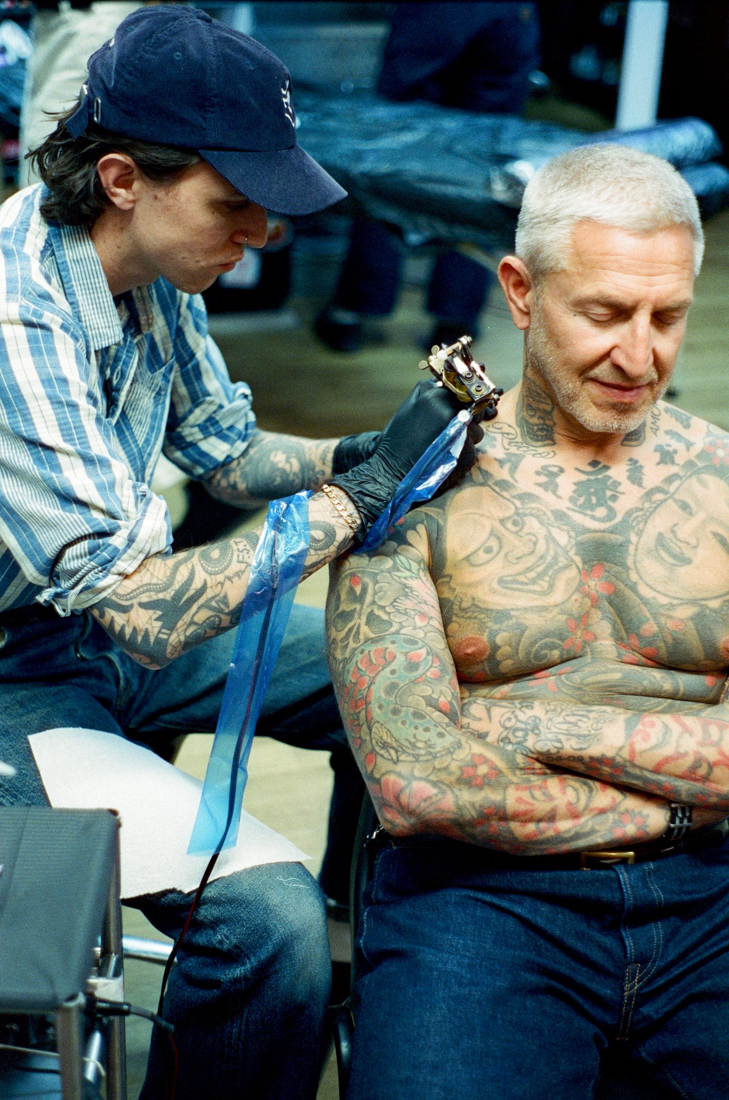 Jake Cordal Tattoo artist working on a client with visible tattoos