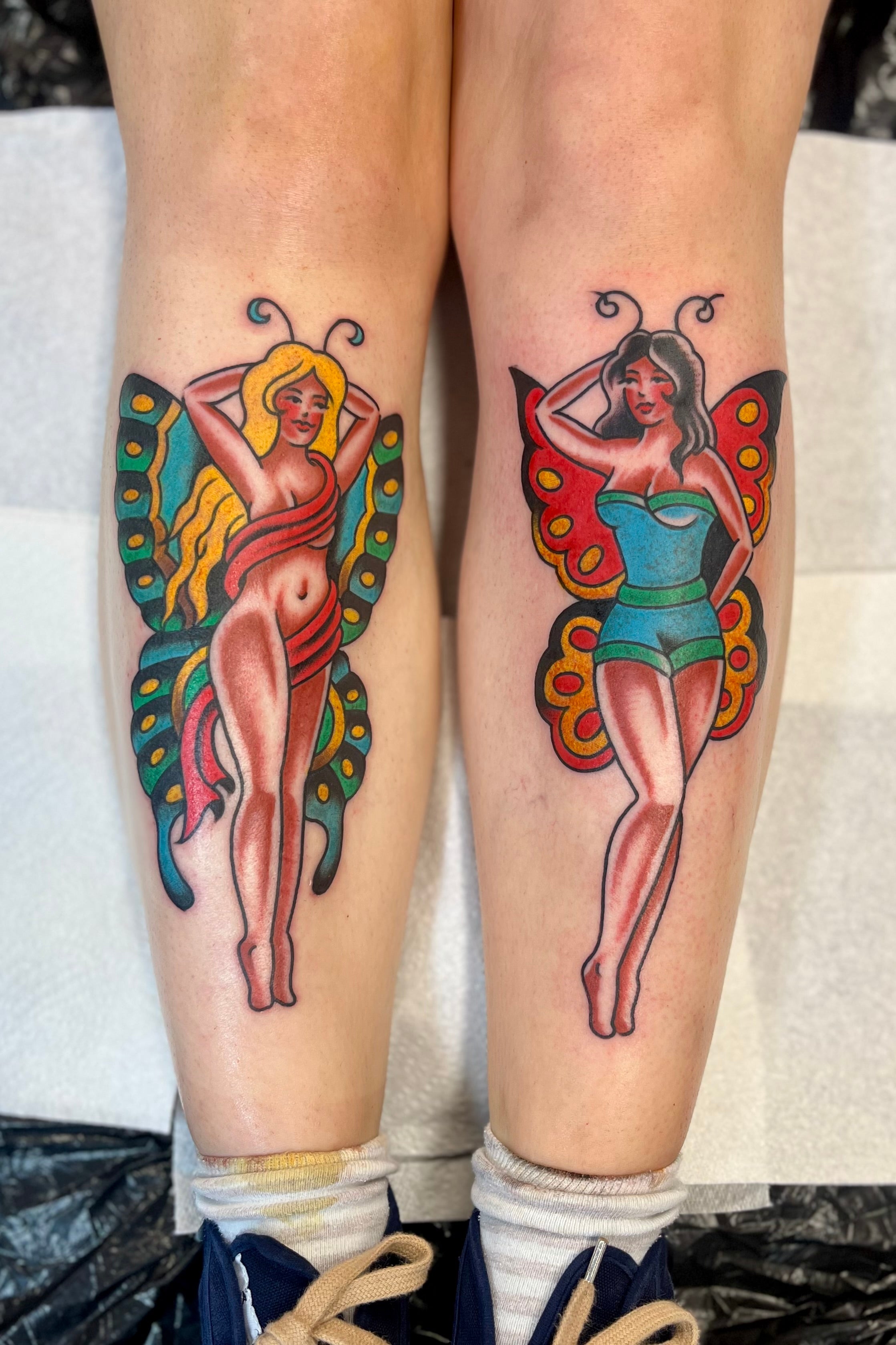 Colourful Bold American traditional classic butterfly pin up girl tattoos on the shins. Tattooed in London