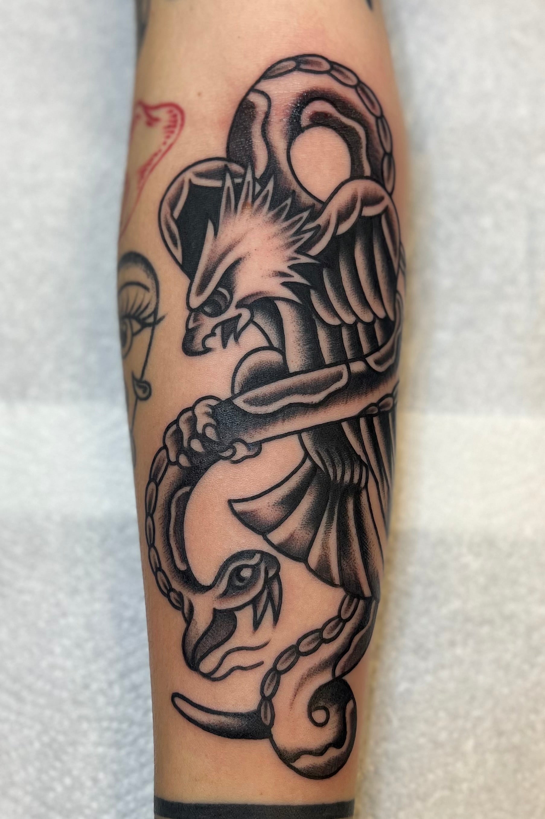 Black and Grey Bold American traditional classic picture machine eagle and snake tattoo. Tattooed in London at frith street tattoo