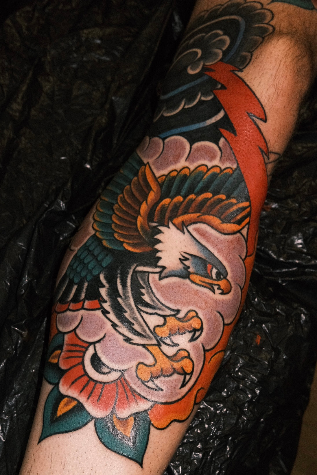 Bold American traditional classic swooping eagle tattoo in colour with full japanese background. Done in London by jake cordal at frith street tattoo
