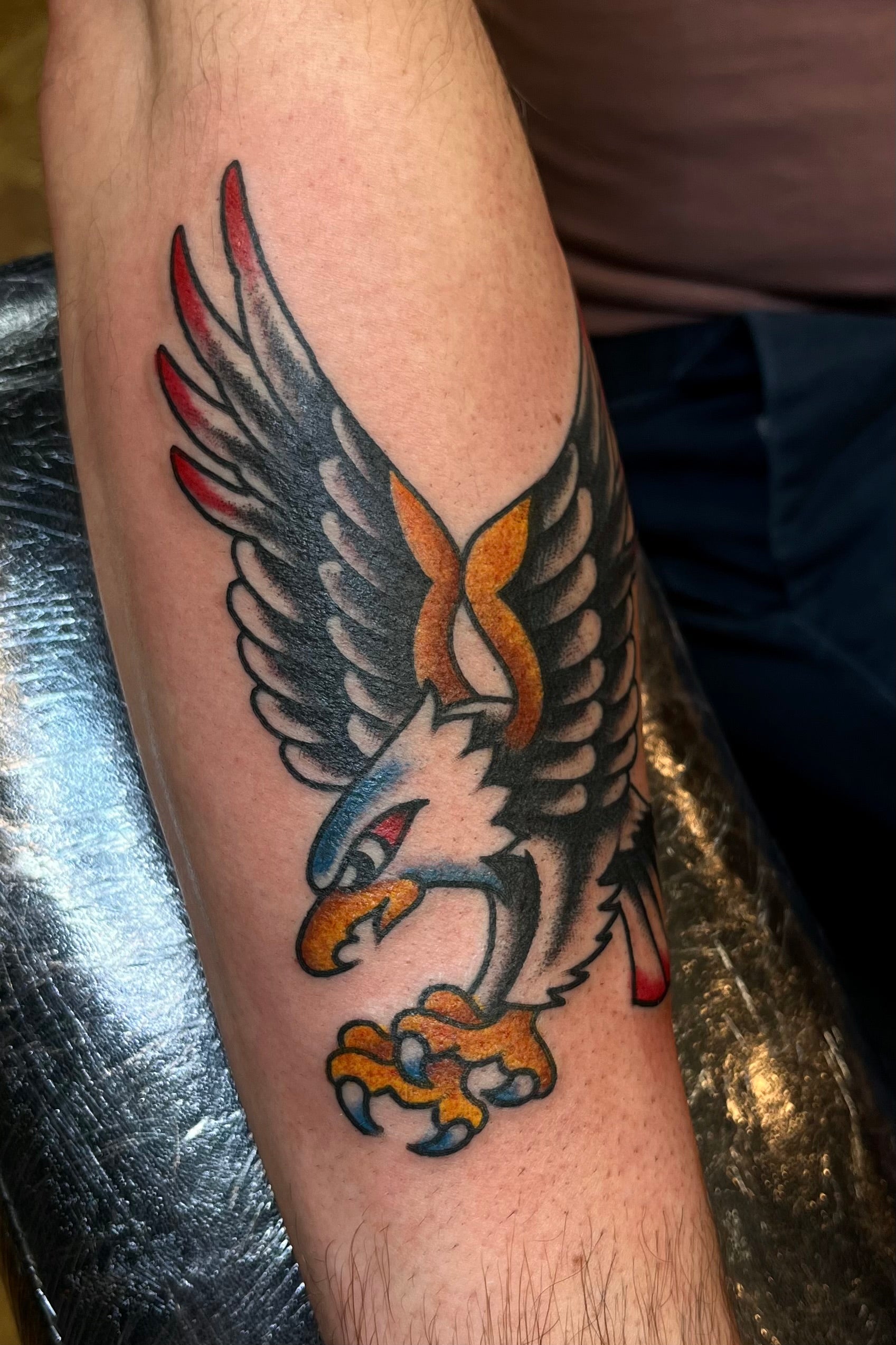 Colourful Bold American traditional classic flying eagle tattoo on the forearm. Tattooed in London at frith street tattoo