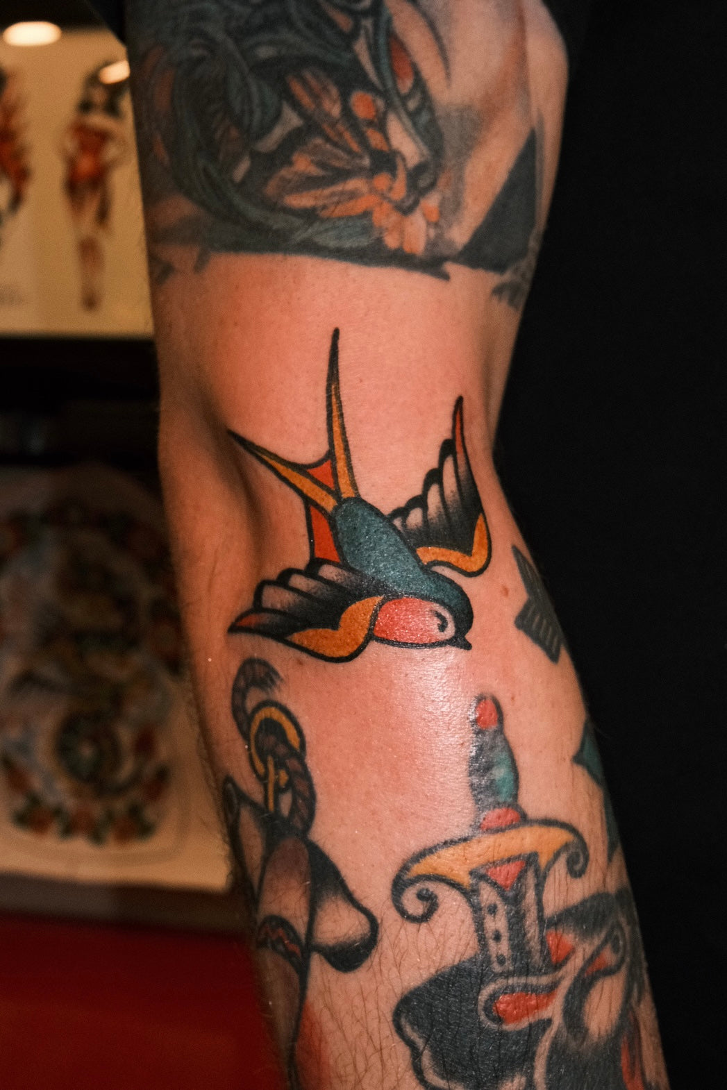 a bold american traditional full colour swallow tattoo on the forearm by jake cordal in frith street tattoo