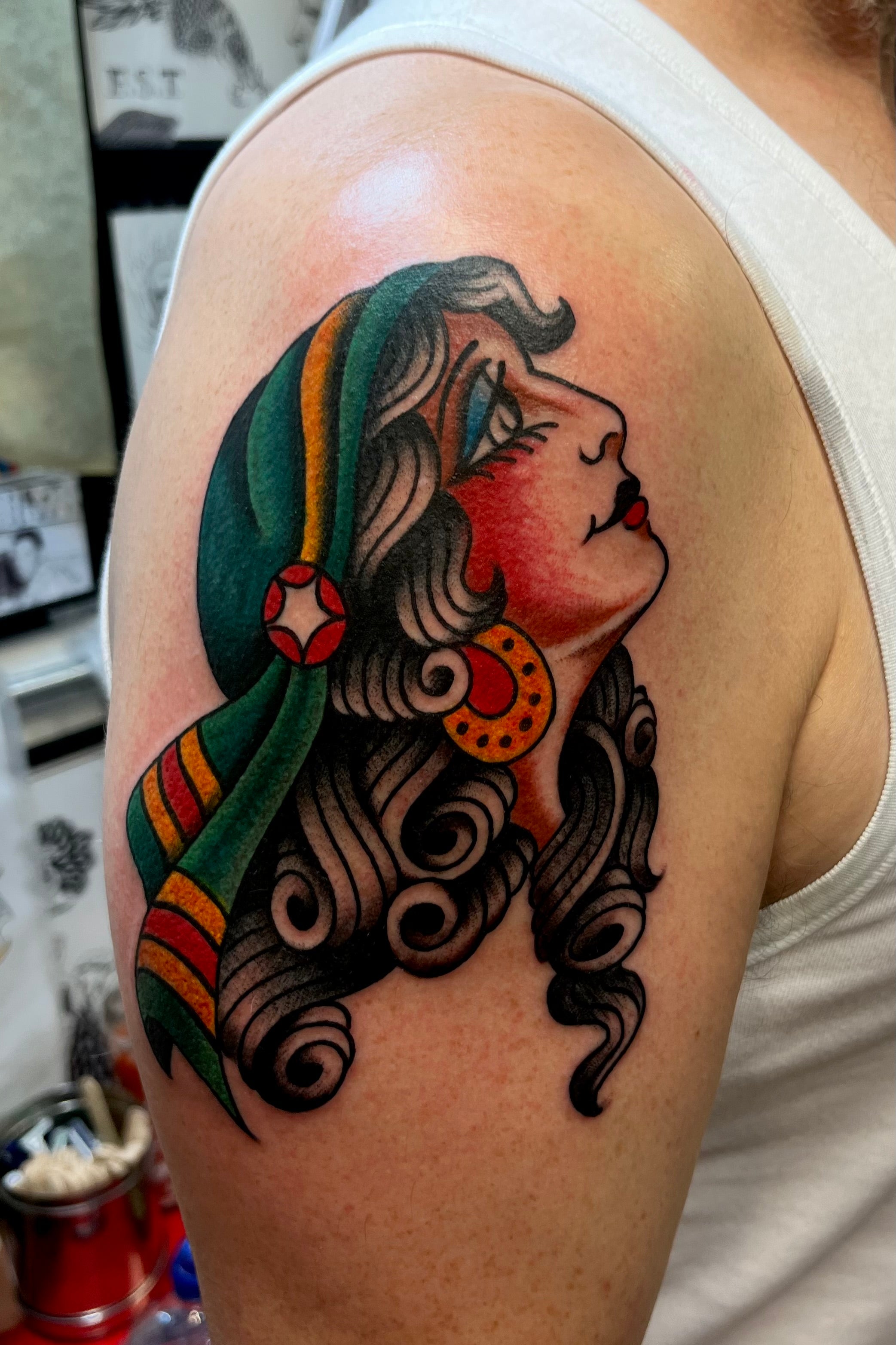 bold american traditional gypsy lady head tattoo with headscarf in full colour, tattooed by jake cordal in london at frith street tattoo