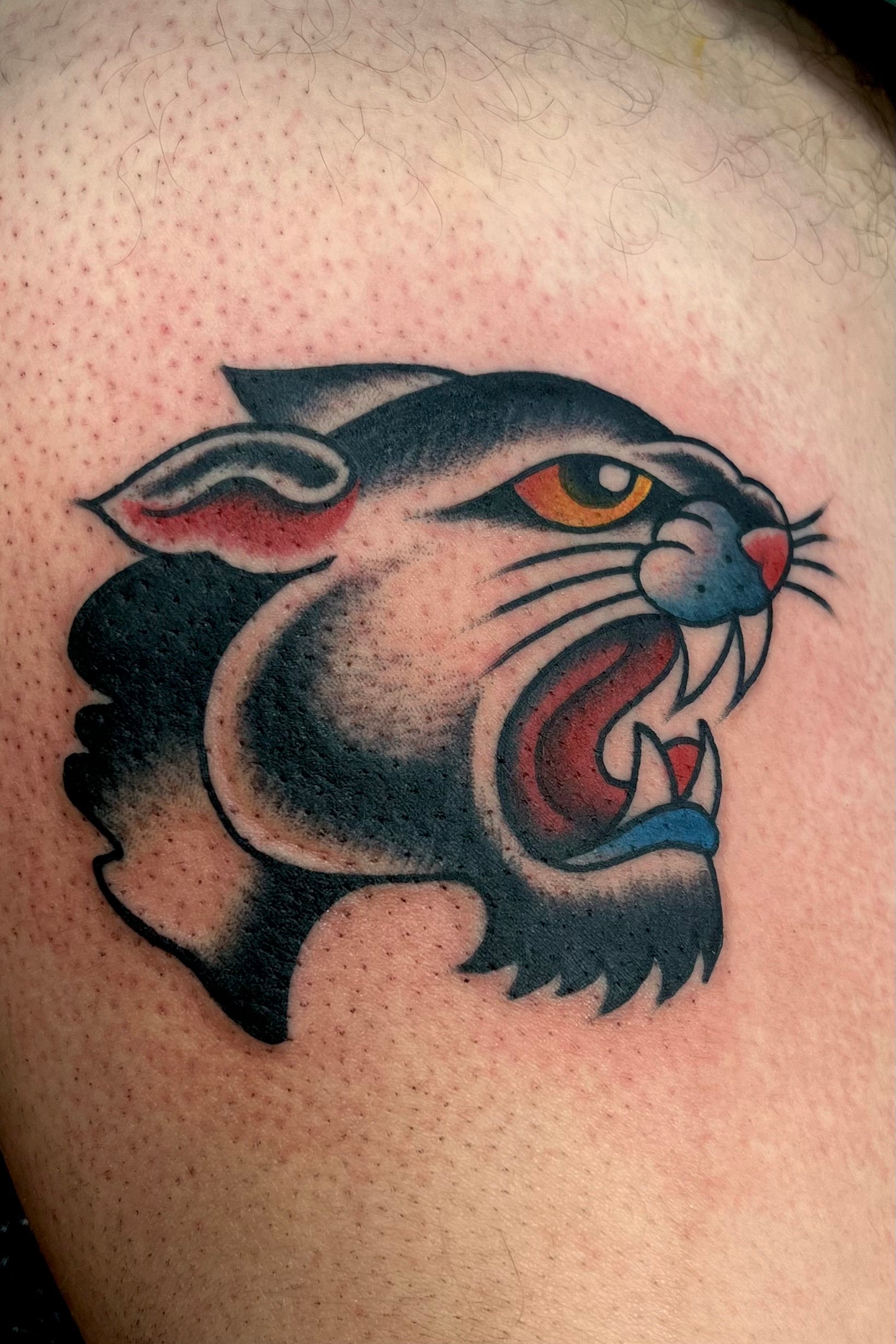 Colourful Bold American traditional classic panther head tattoo. Tattooed in London.