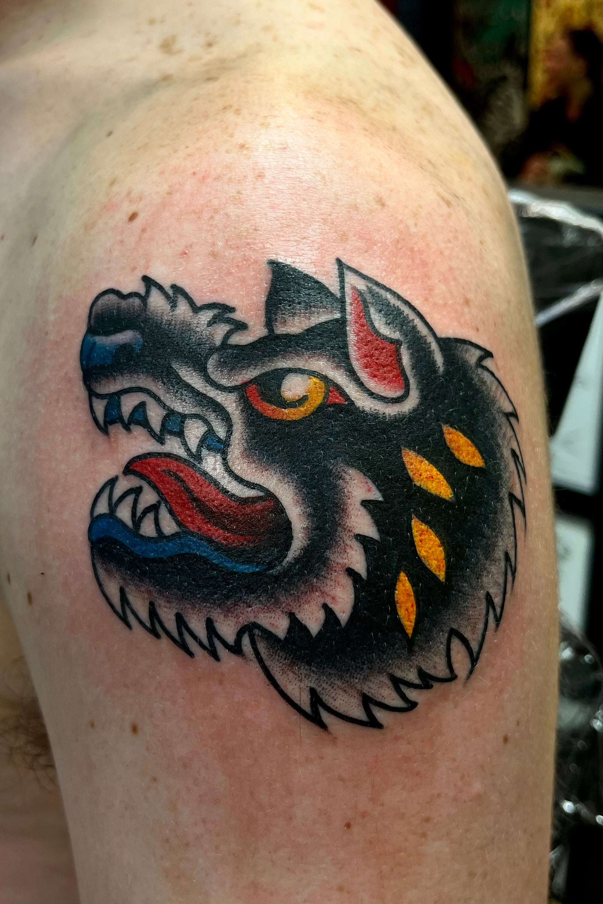 Colourful Bold American traditional classic wolf head tattoo. Tattooed in London at frith street tattoo