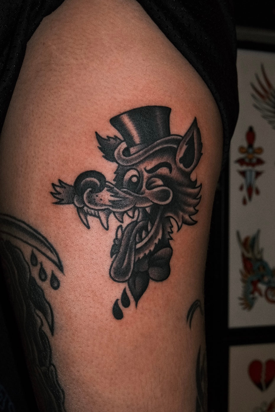 Bold American traditional classic black and grey wolf tattoo with a top hat. Done in London by jake cordal at frith street tattoo